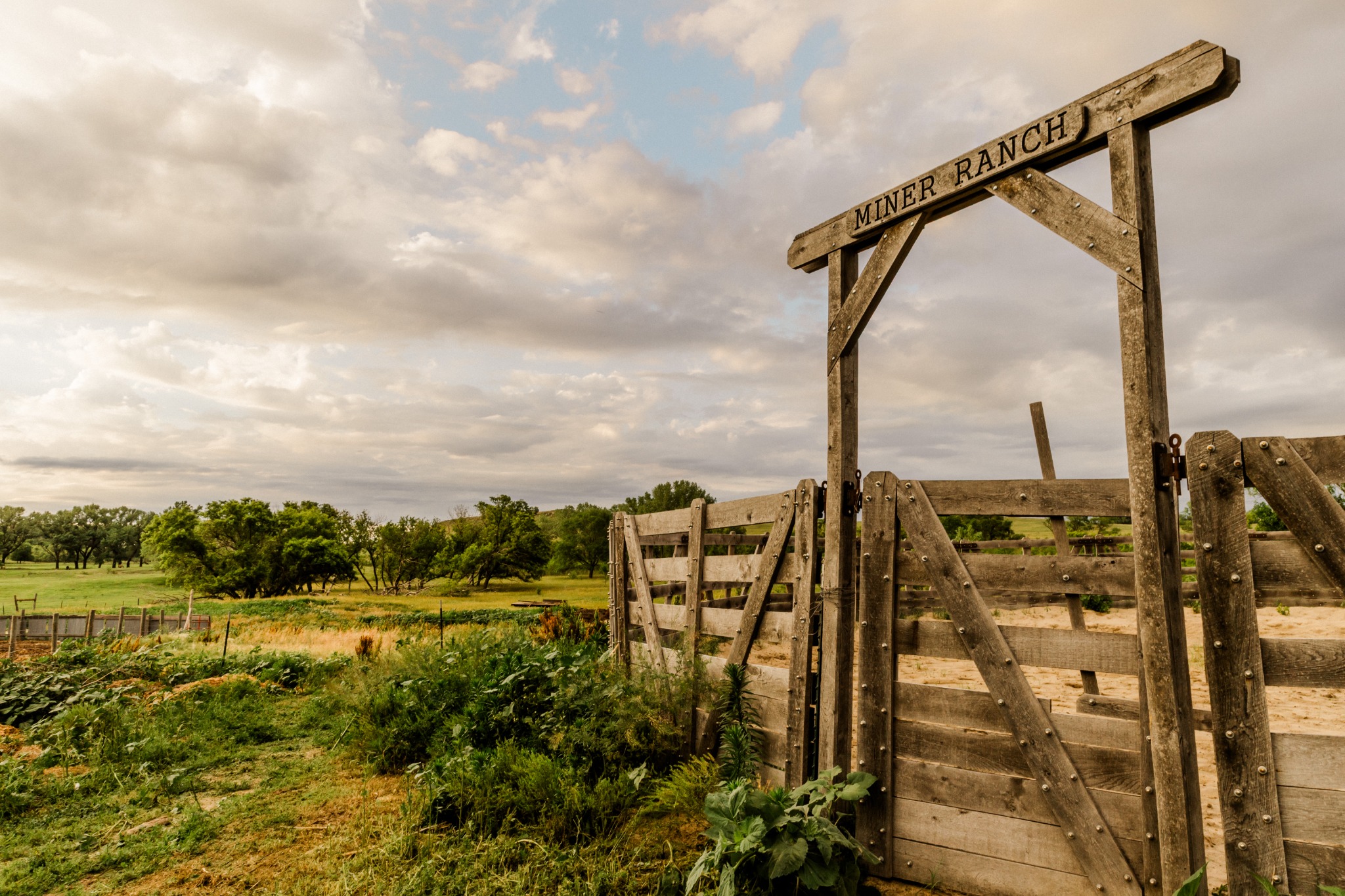 The historic Miner Ranch gate beneath a wide prairie sky